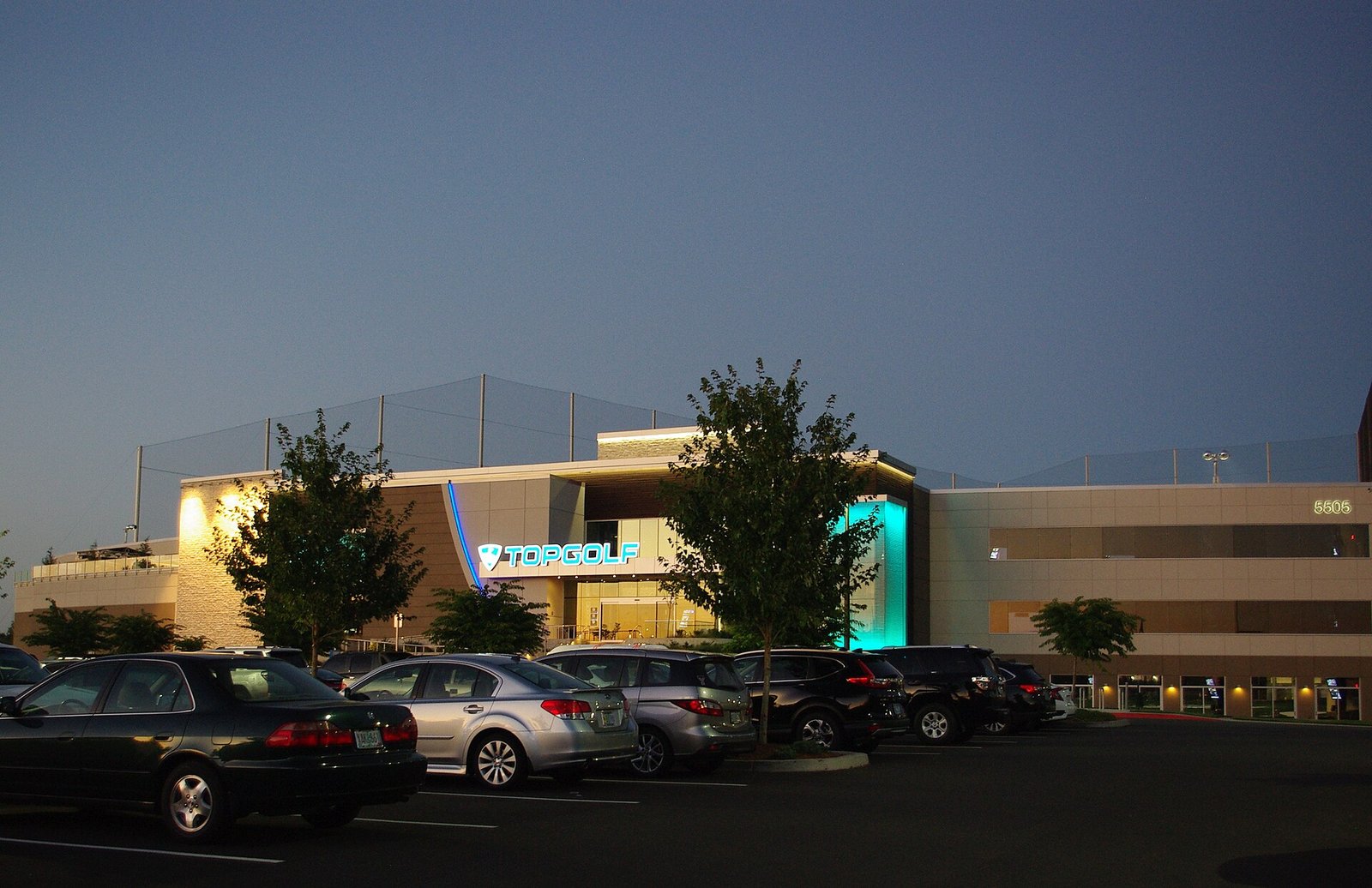 Topgolf Dubai at dusk — a Topgolf venue with its sign lit up.