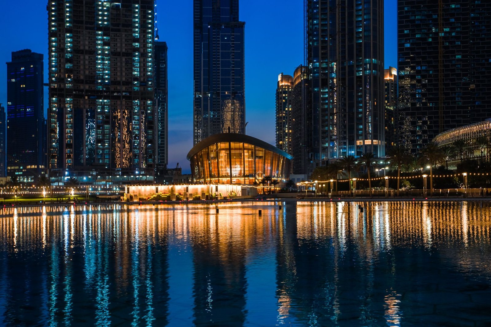 Dubai Opera lit up at night across Burj Lake, Downtown Dubai