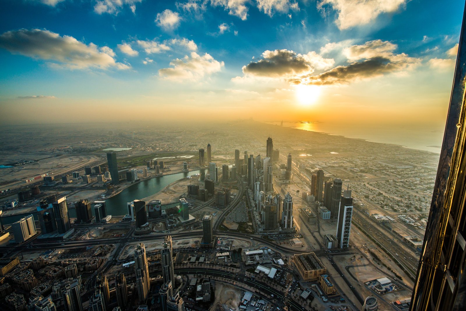 View across Dubai towards the Gulf at sunset from the Burj Khalifa observation deck
