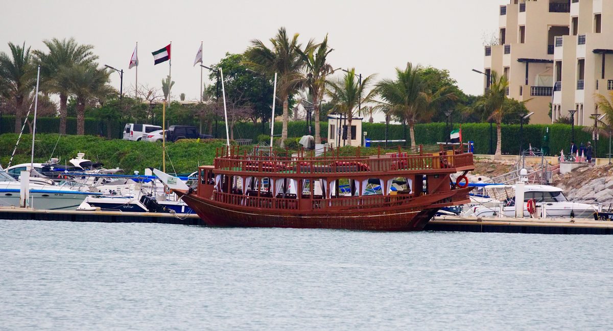 Dhow cruise Dubai prices start with boats like this one: a traditional wooden dhow moored and ready for the evening cruise