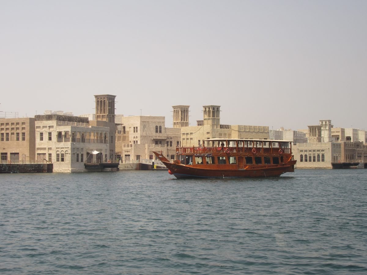 A traditional wooden dhow under way in Dubai, the classic boat most marina dhow cruise dinners use