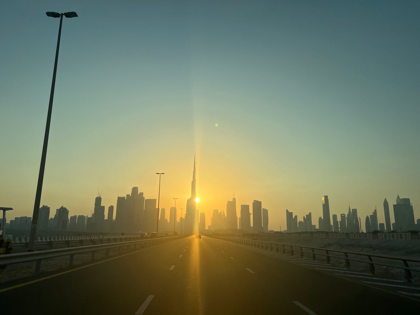 Driving towards the Downtown Dubai skyline and the Burj Khalifa at sunset