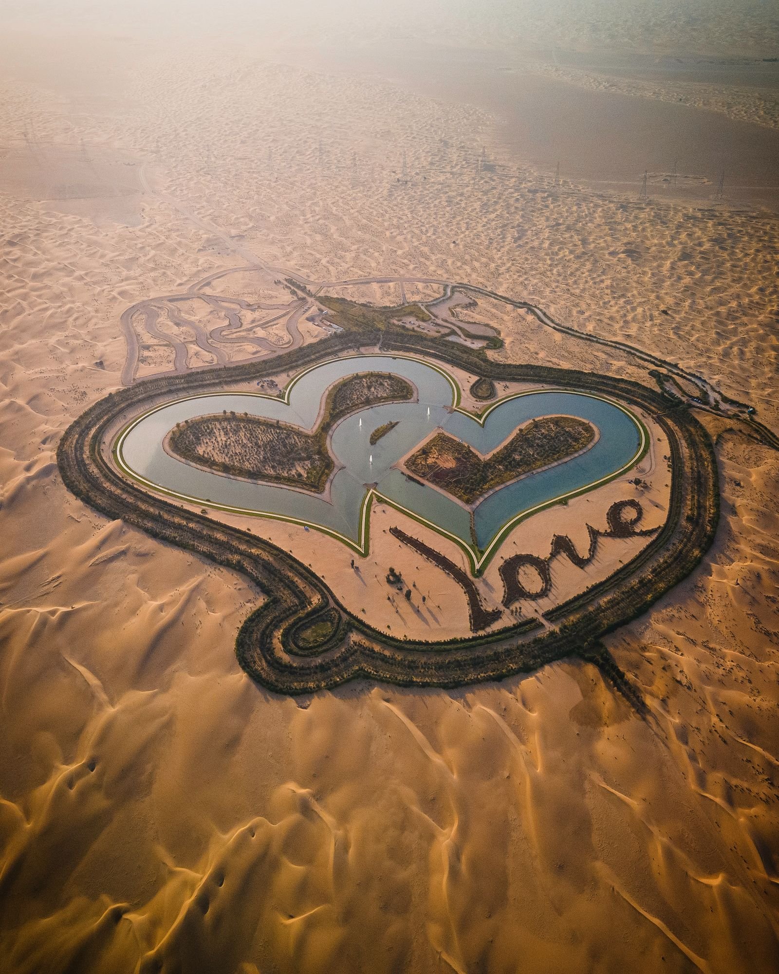Love Lake Dubai at golden hour surrounded by desert dunes
