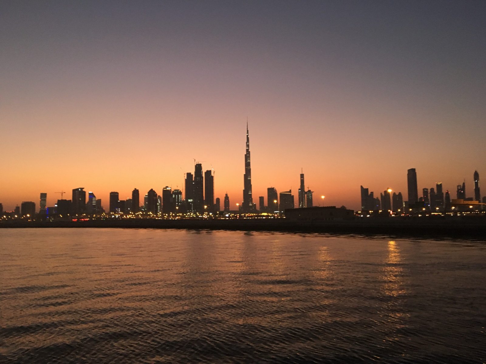 Dubai weather in winter: the Dubai skyline across the water under a dramatic sky