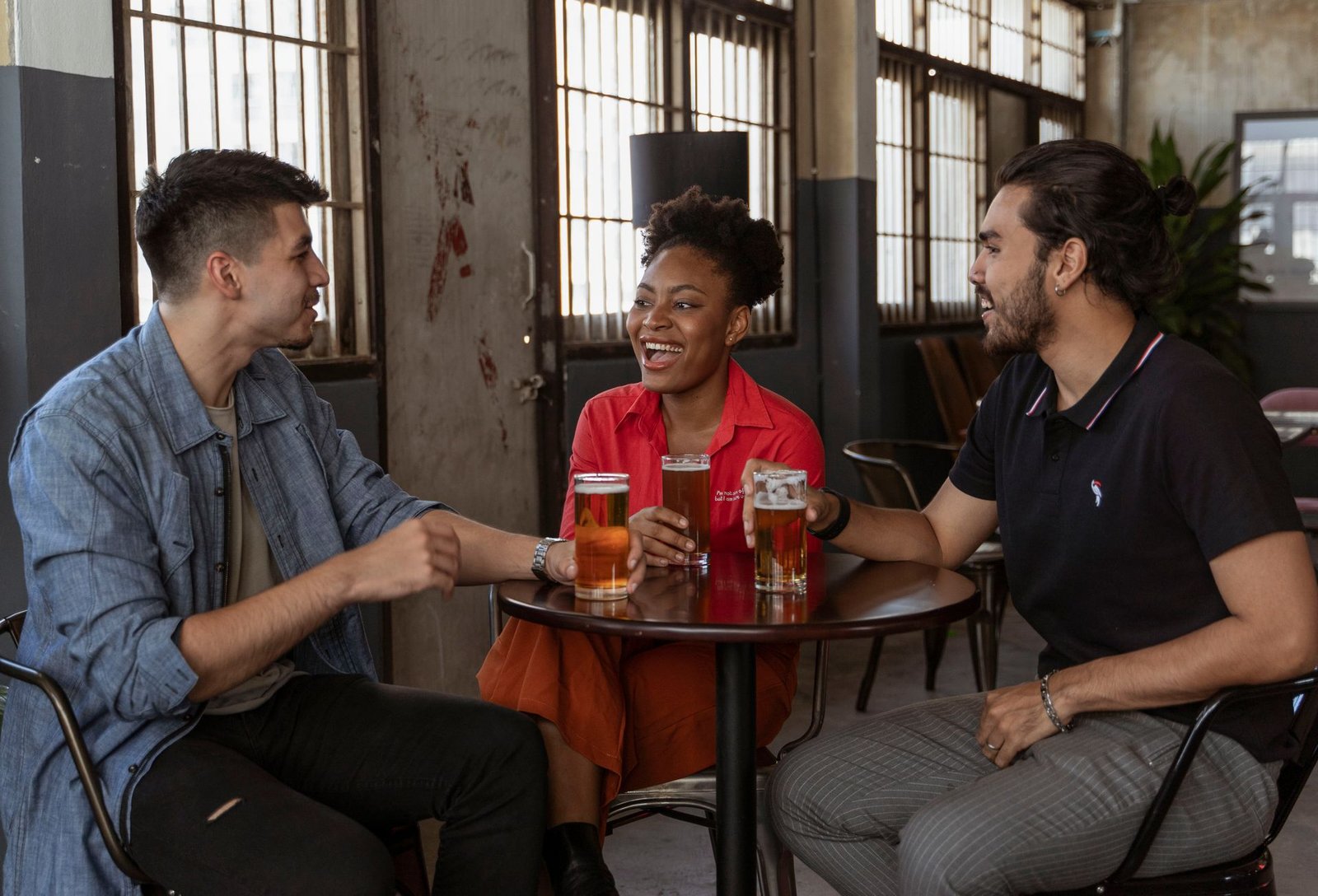 Friends laughing at a small comedy club