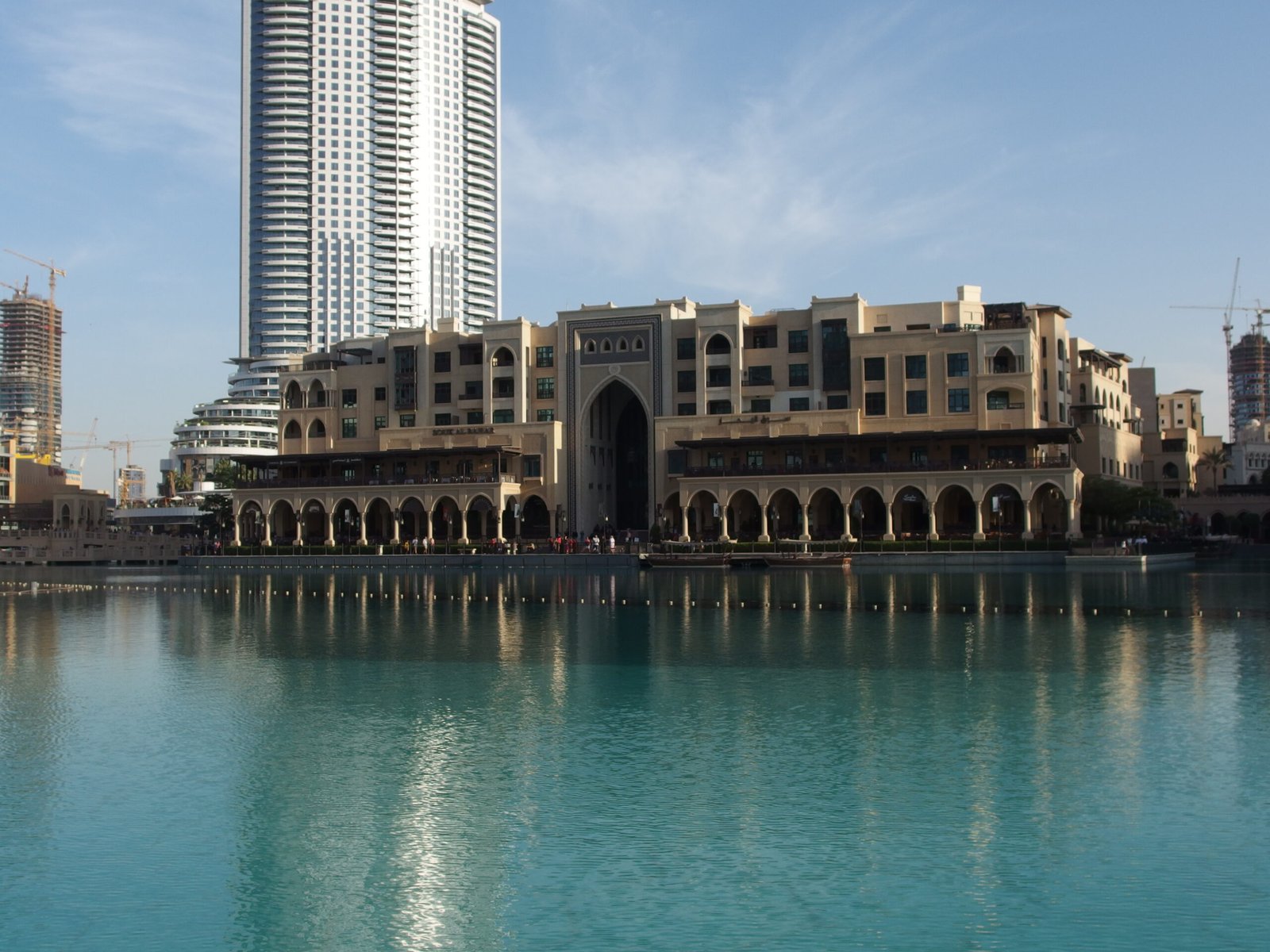 Souk Al Bahar across the Burj Lake in Downtown Dubai, with a tower behind it