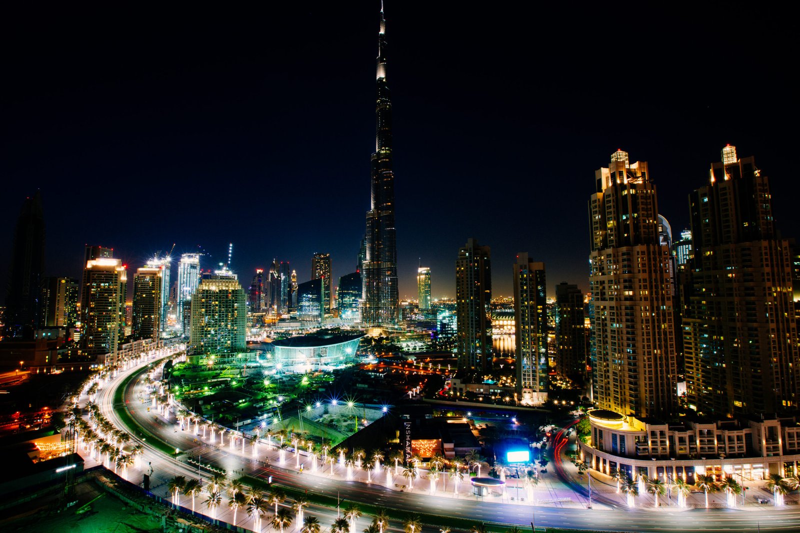 The Burj Khalifa lit up at night above the streets of Downtown Dubai