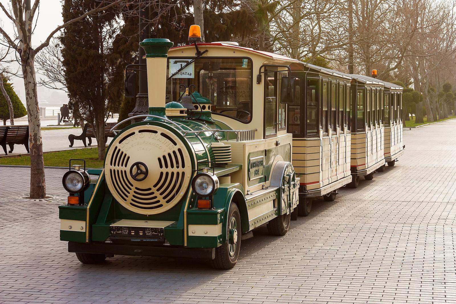A small park train carrying visitors between zones (general photo)
