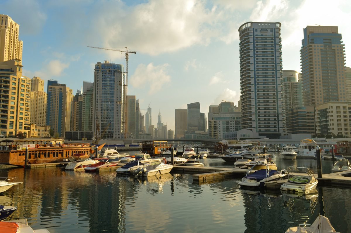Boats moored along Dubai Marina in the early evening, waiting for the night's dinner cruises