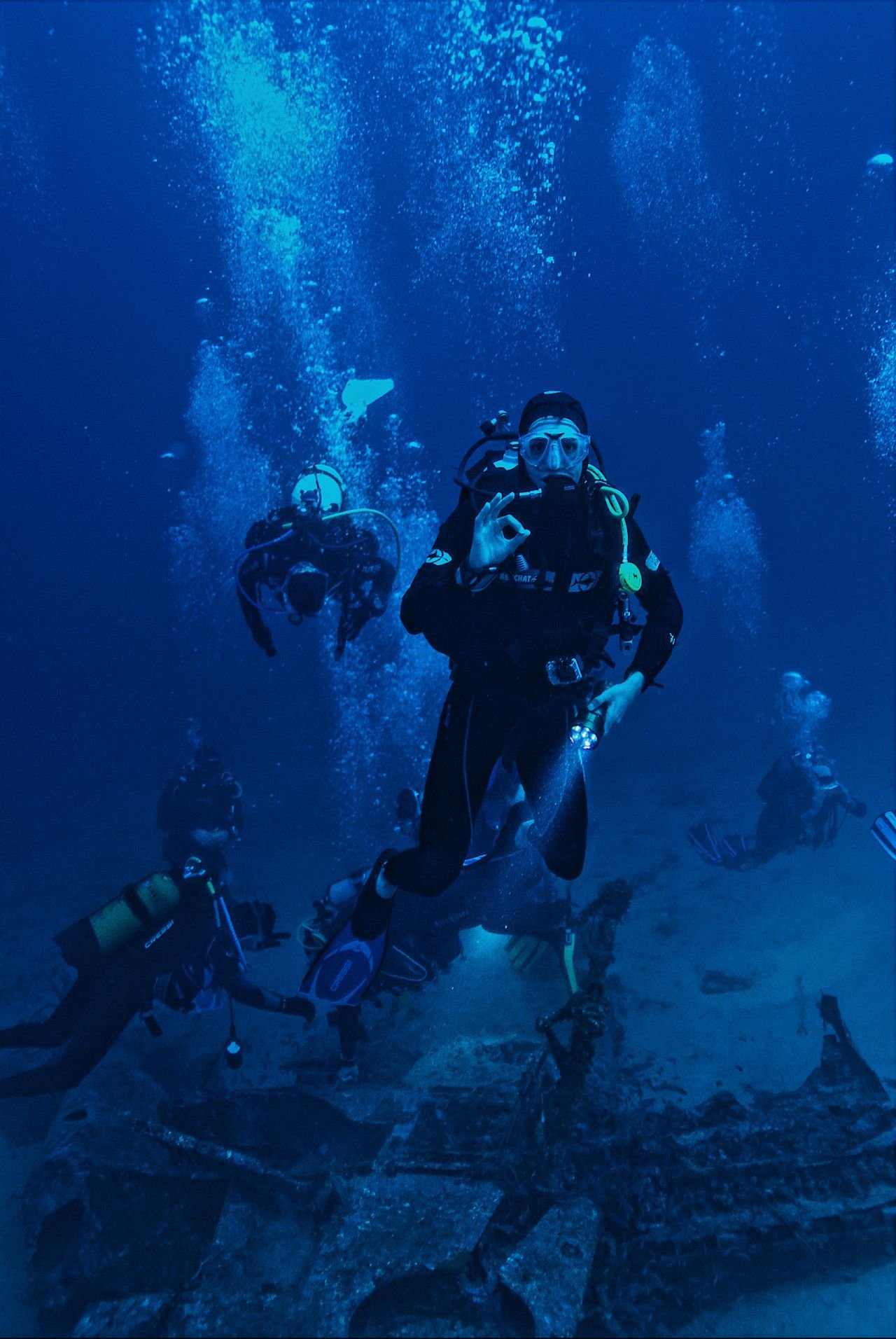 Divers descending into the sunken city at Deep Dive Dubai