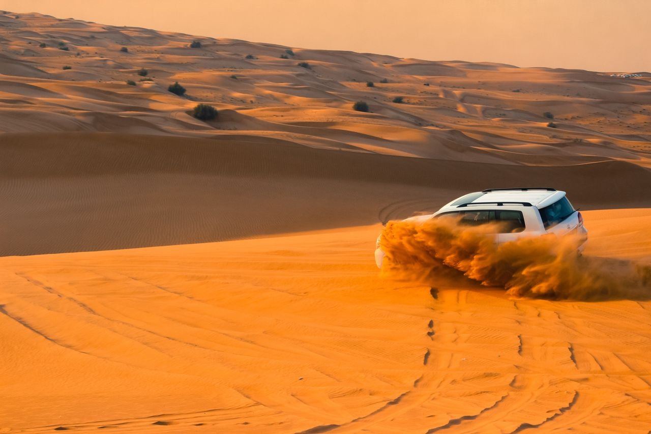 Safari SUV crossing the Dubai desert dunes
