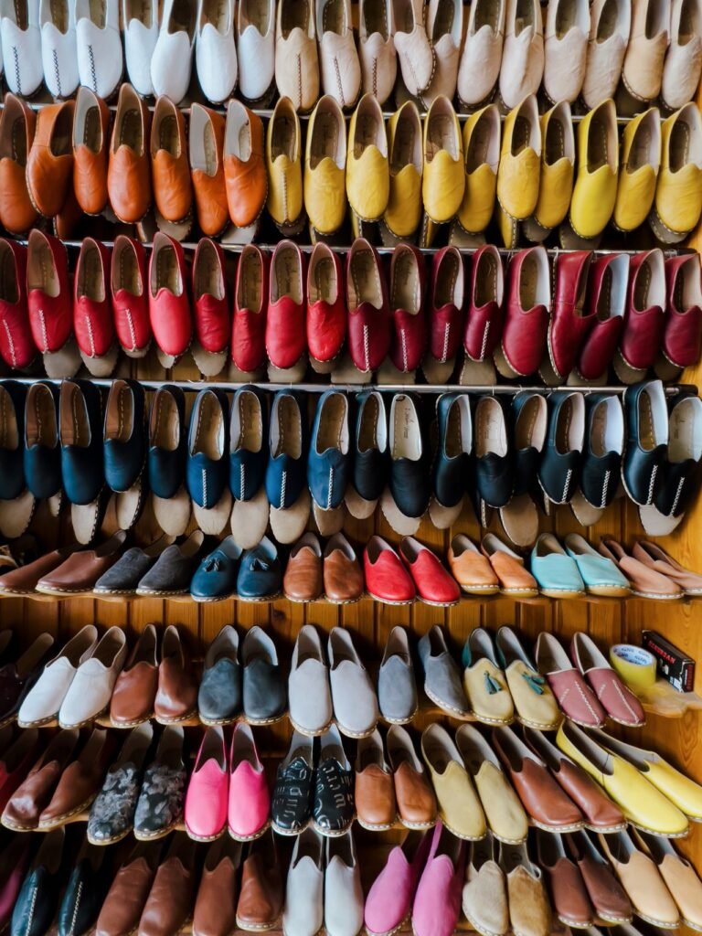 Wall of colourful shoes on sale at a Dubai outlet mall store