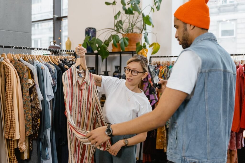 Shoppers checking clothes on a rack at an outlet mall