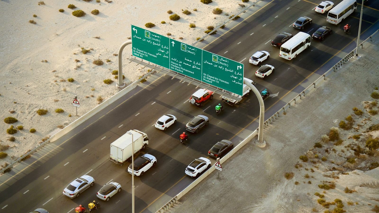 Aerial view of a Dubai highway with desert on both sides